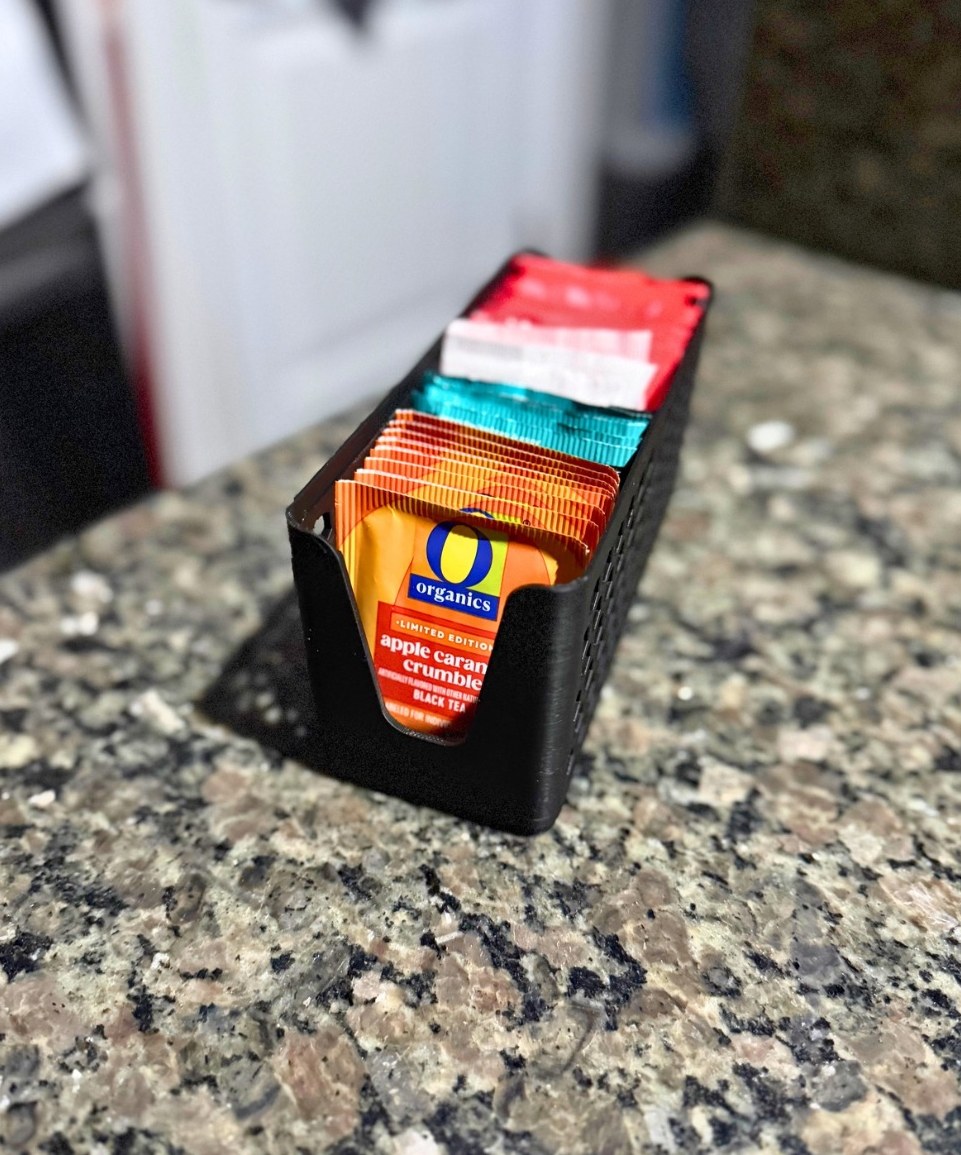 Black honeycomb organizer loaded with packets