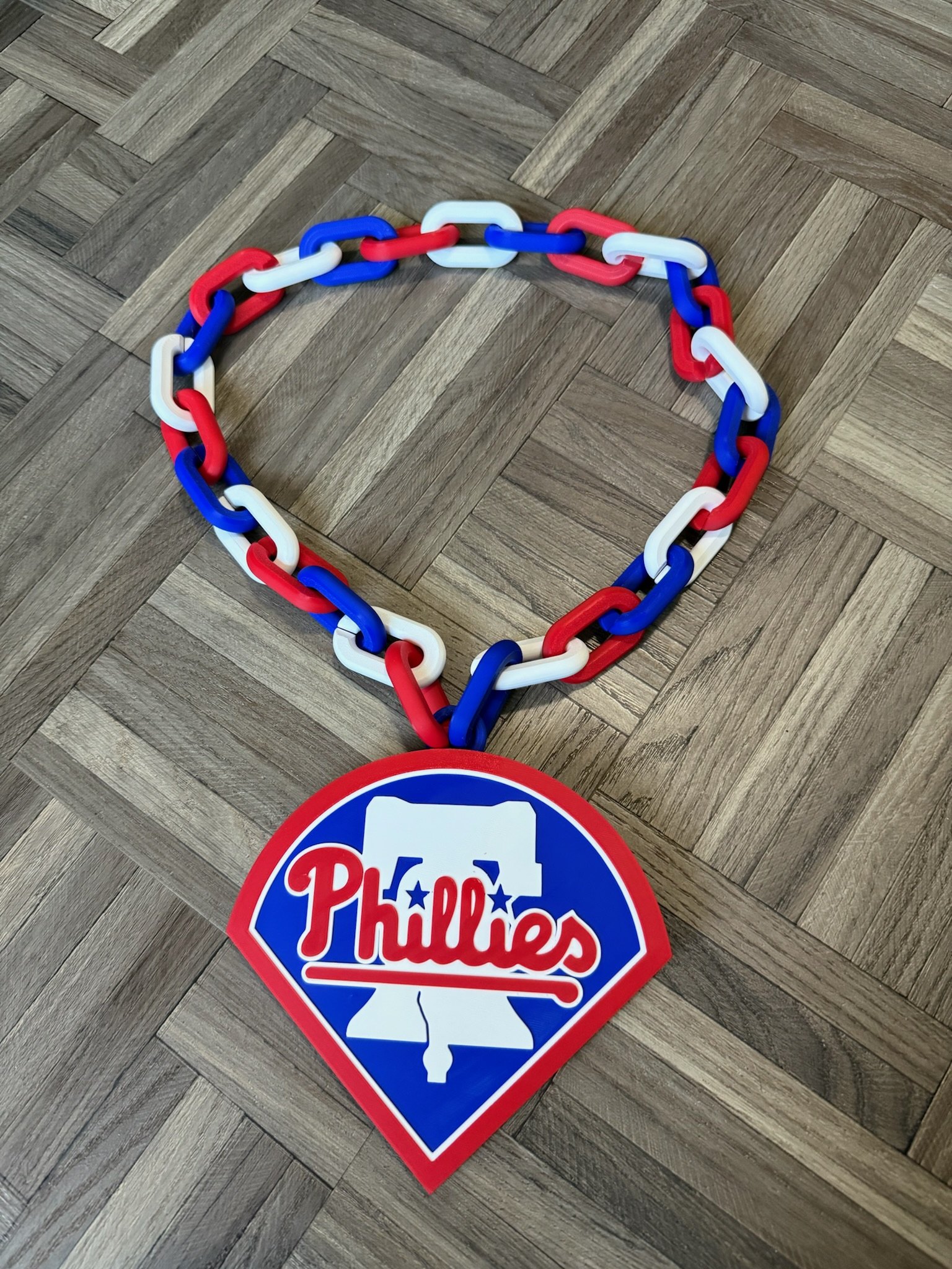 3D-printed Phillies home-plate pendant on red white and blue chain