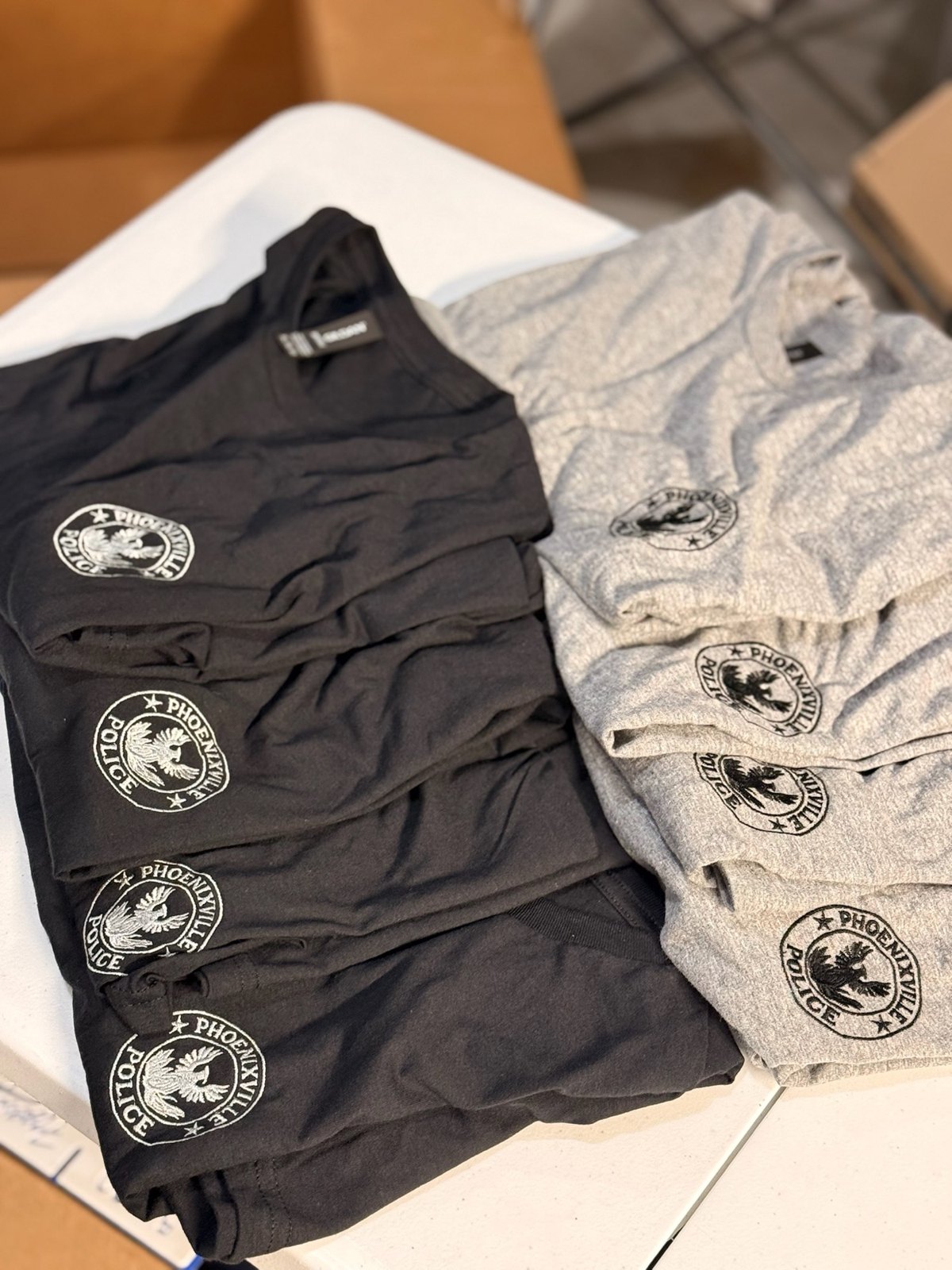 Finished Phoenixville Police tees — black and grey stacks